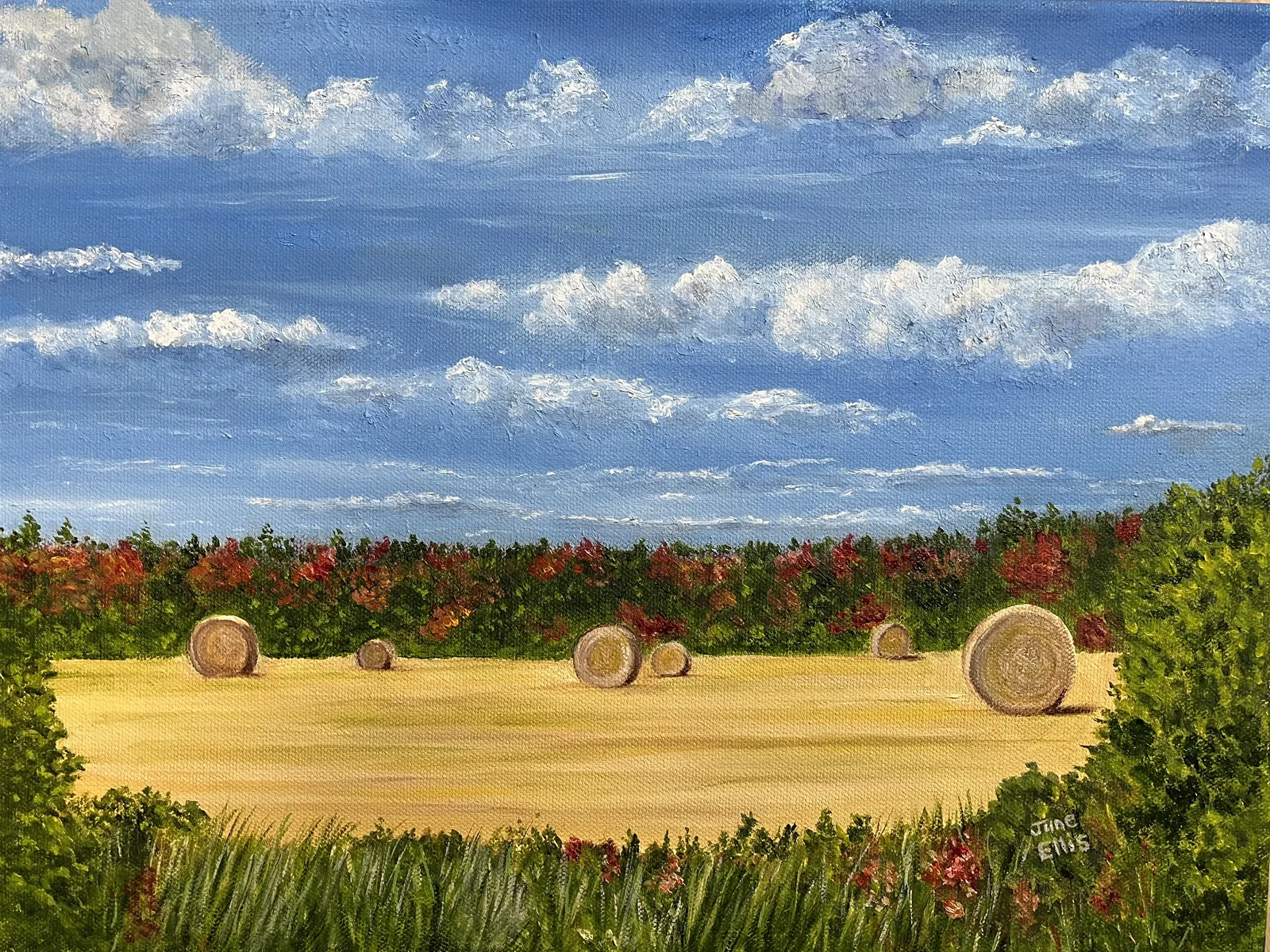 An original oil painting of round bales in the field with autum colours in the background