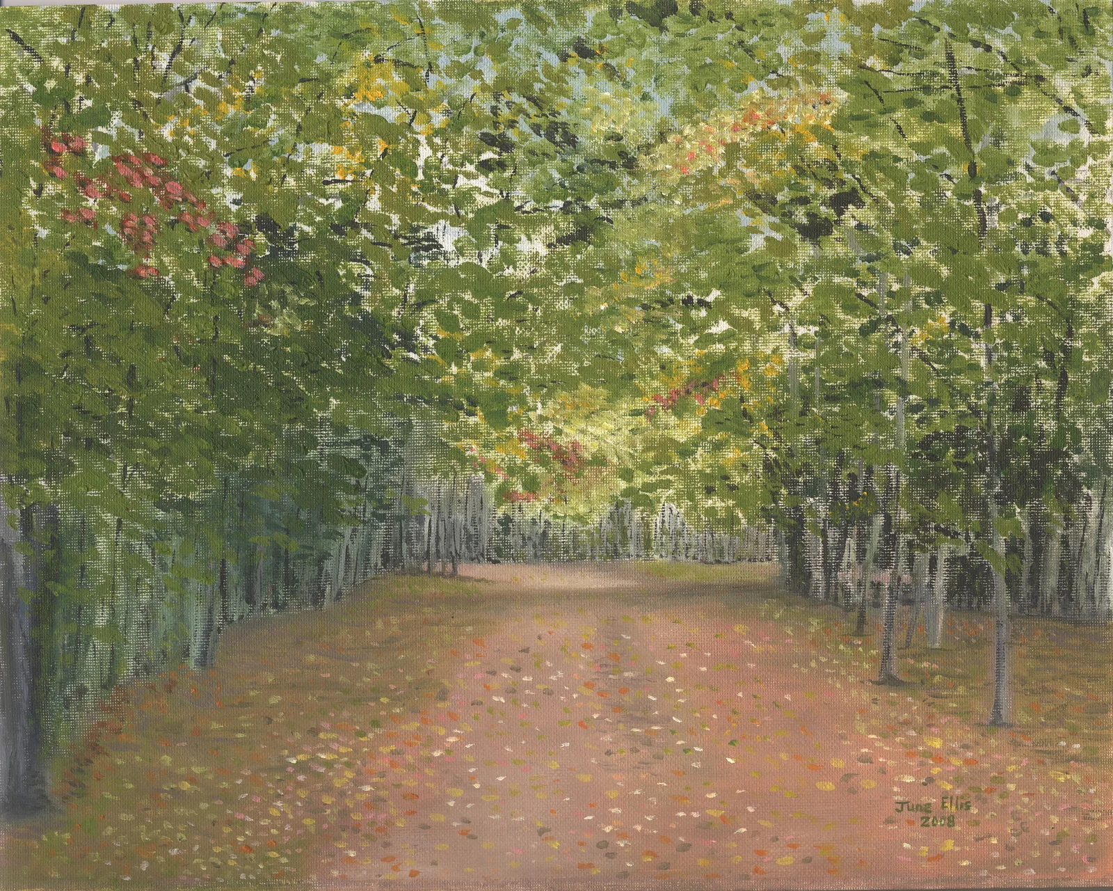 Red dirt road leading through the woods in the fall