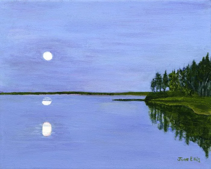 Reflection of the moon in a blue sky and water