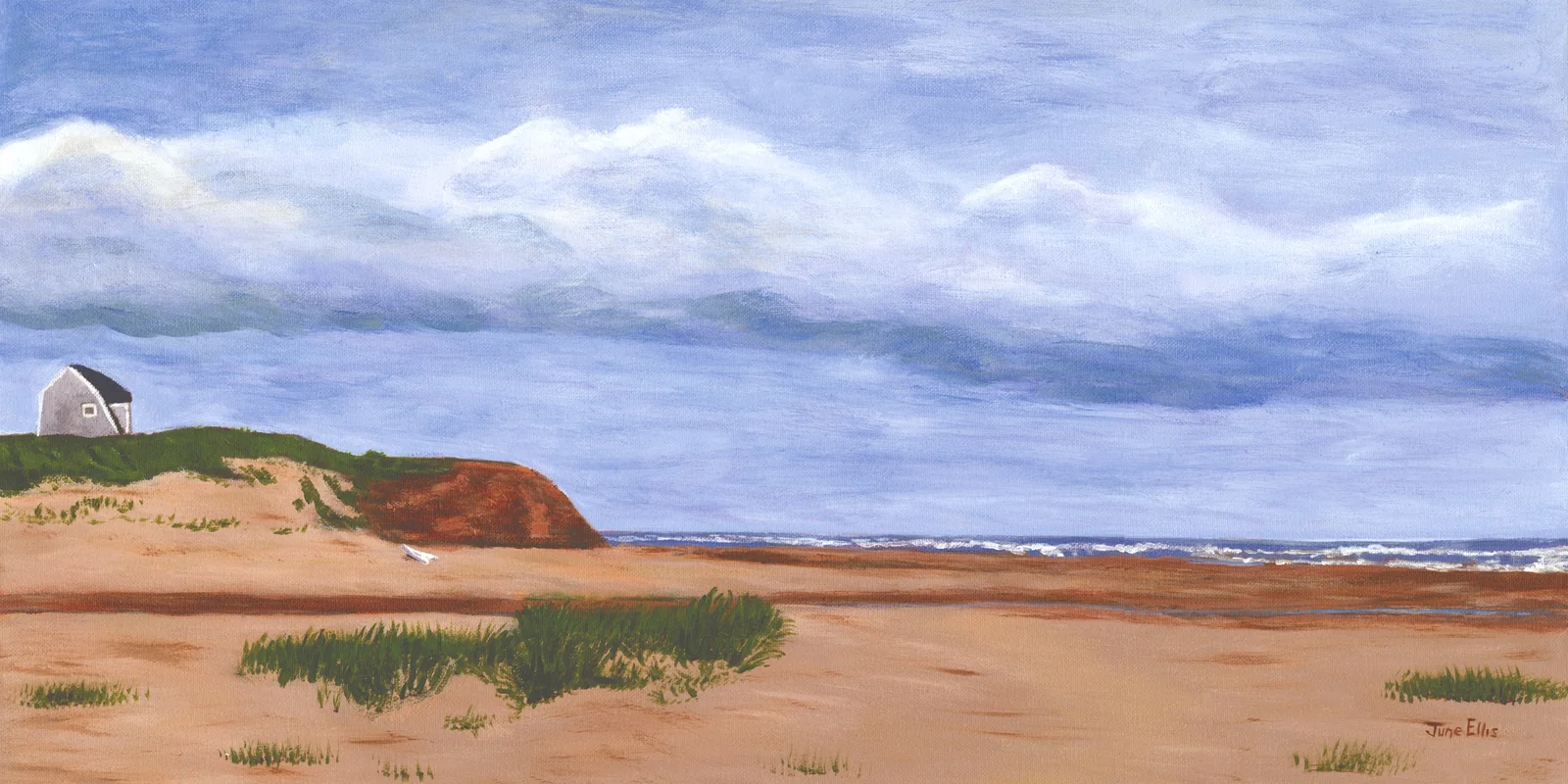 Sandy beach and clouds with cottage and red cliffs in the distance